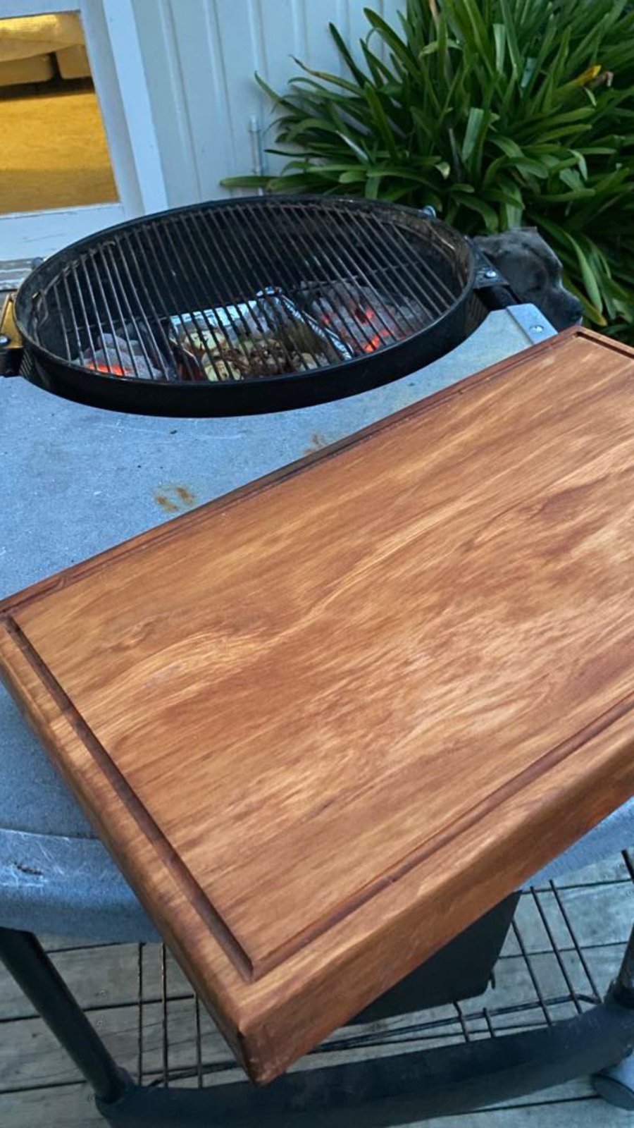 Smoked tomahawk steak resting on a Woodworkers Shed board